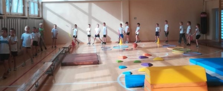 Powiększ obraz: Uczniowie podczas zajęć na sali gimnastycznej